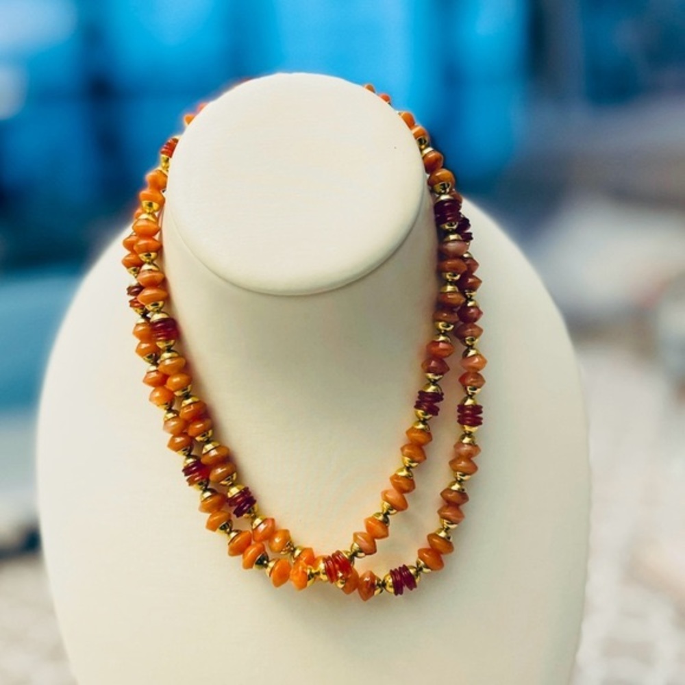 Vintage 70s necklace of rust-colored beads.  32”.